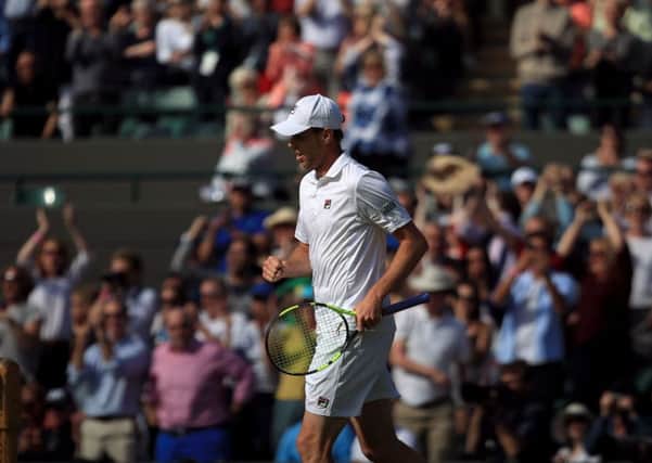 Sam Querrey celebrates beating Novak Djokovic on day six of the Wimbledon Championships at the All England Club, Wimbledon.