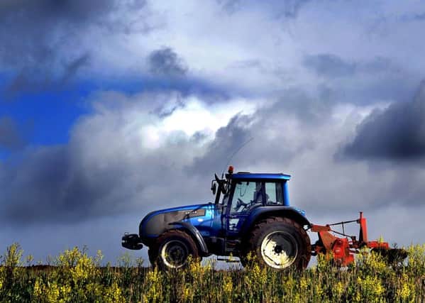 A farmer drives his tractor along a field near Bramham