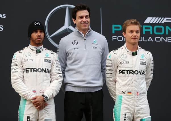 Mercedes drivers Lewis Hamilton (left) and Nico Rosberg (right) with Executive Director Toto Wolff.