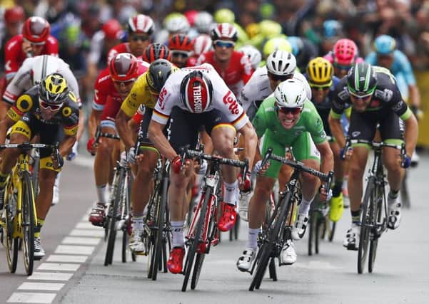 Britain's Mark Cavendish, wearing the best sprinter's green jersey, is about to overhaul Germany's Andre Greipel to win the third stage of the Tour de France (Picture: Peter Dejong/AP).