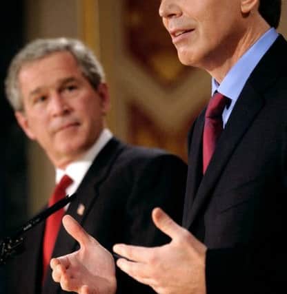 Tony Blair alongside former US President George Bush.