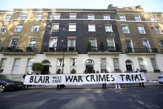 Protesters hold a banner outside the London home of former Prime Minister Tony Blair ahead of the publication of the Chilcot report into the Iraq war.