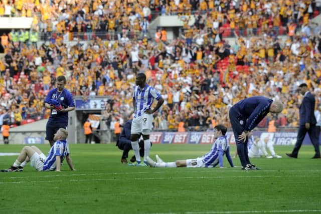 Sheffield Wednesday's players are left dismayed by their Championship play-off final defeat to Hull at Wembley. Picture: Steve Ellis.