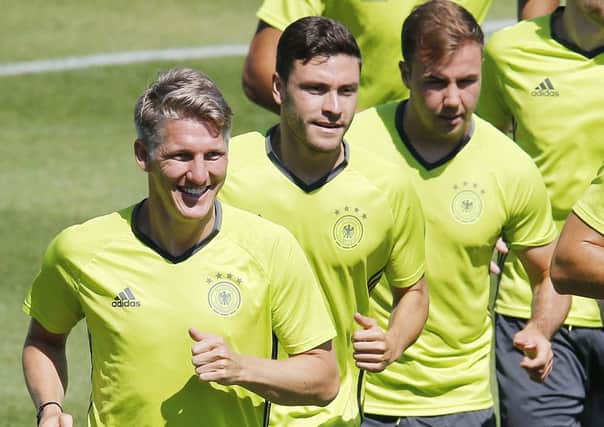 Bastian Schweinsteiger, Jonas Hector and Mario Goetze, from left, attend the last training session of the German national football team at their base camp in Evian-Les-Bains, France on Wednesday. (AP Photo/Michael Probst)