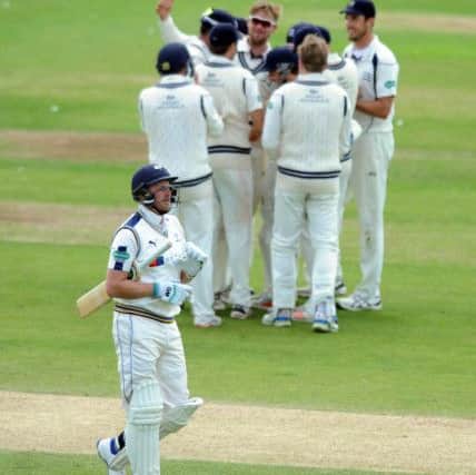 Yorkshire's Andrew Gale trudges off as the Middlesex players celebrate.