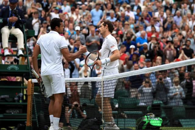Jo-Wilfried Tsonga (left) and Andy Murray shake hands after their match. Picture: John Walton/PA