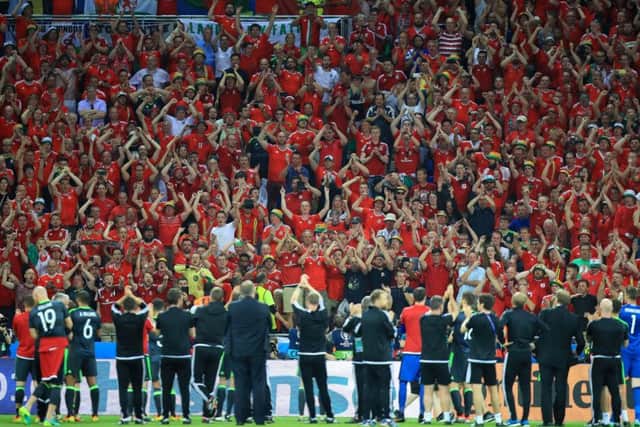 Wales fans cheer the players and staff following their defeat to Portugal. Picture: Mike Egerton/PA