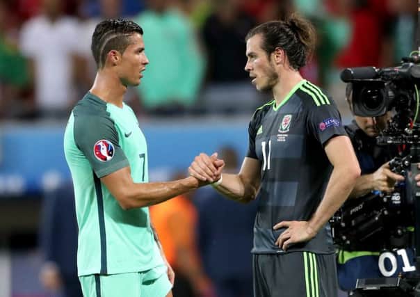 Portugal's Cristiano Ronaldo (left) and Wales' Gareth Bale (right) shake hands after the game in Lyon. Picture: Nick Potts/PA