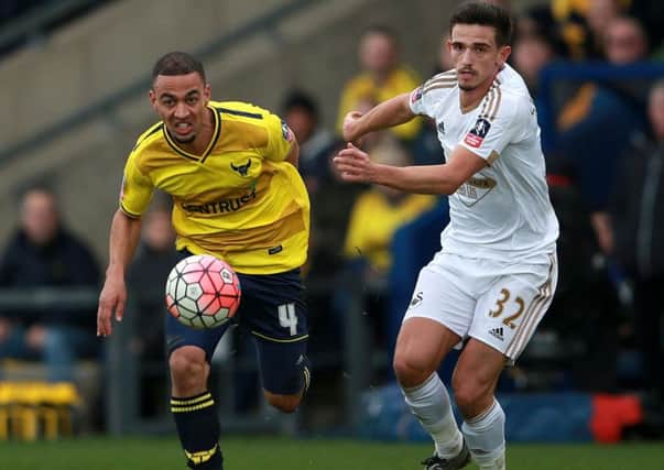 Oxford United's Kemar Roofe (left) in action against Swansea City in the FA Cup.