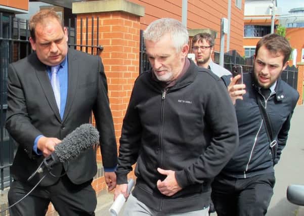 Paul Grange (centre) leaves Worcester Magistrates' Court, Worcester, where he was fined Â£600 after he was arrested for wearing a T-shirt mocking the 96 Liverpool fans who died in the Hillsborough disaster. PA Photo.
