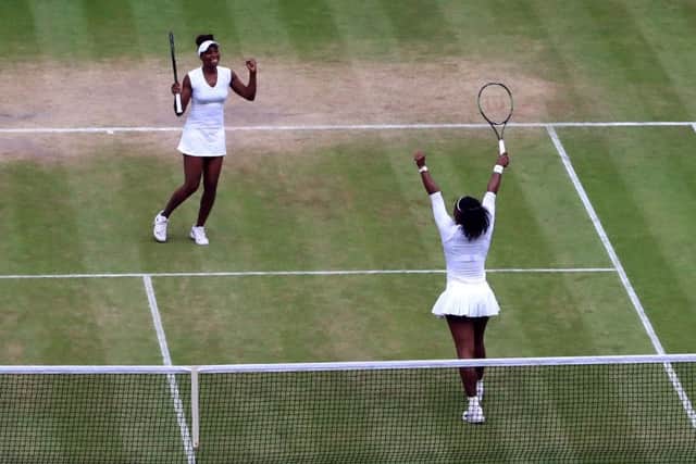Serena Williams and Venus Williams (top) celebrate winning the ladies doubles on Saturday. Picture: John Walton/PA