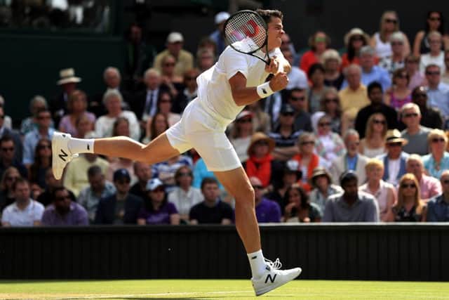 Milos Raonic hits a backhand winner against Andy Murray. Picture: Adam Davy/PA.