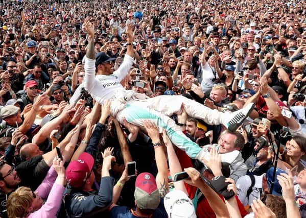 Mercedes Lewis Hamilton celebrates his victory with the crowd at Silverstone. Picture: David Davies/PA.