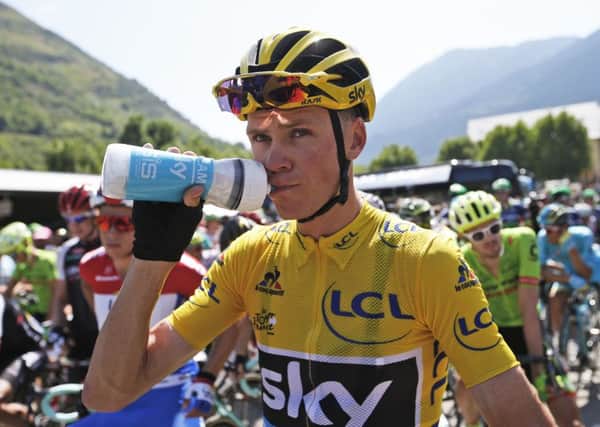 Britain's Chris Froome, wearing the overall leader's yellow jersey, drinks prior to the start of the ninth stage. Picture: AP/Christophe Ena.