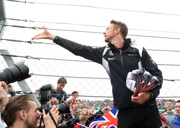END OF THE ROAD? McLaren's Jenson Button hands out caps before the 2016 British Grand Prix at Silverstone. Picture: David Davies/PA.