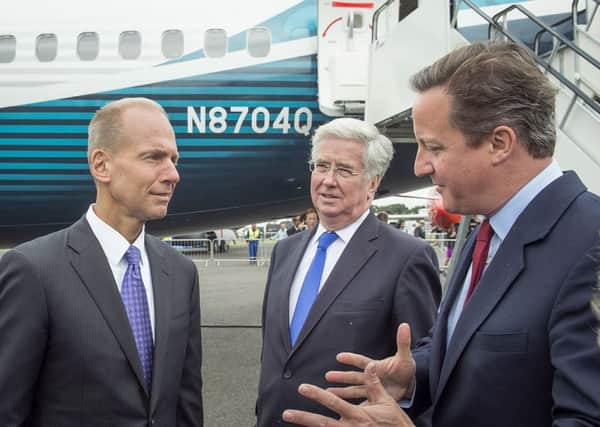 Dennis Muilenburg, chairman of Boeing, Secretary of State for Defence Michael Fallon and Prime Minister David Cameron at Farnborough Airshow