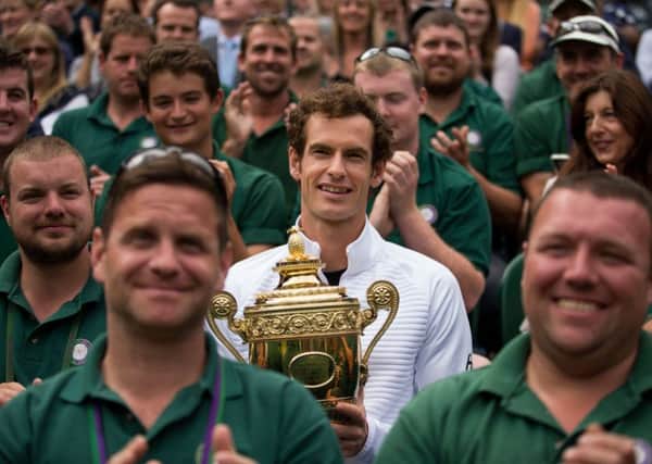 Andy Murray poses for a photograph with the ground staff on Centre Court at Wimbledon (Picture: Steve Paston/PA).