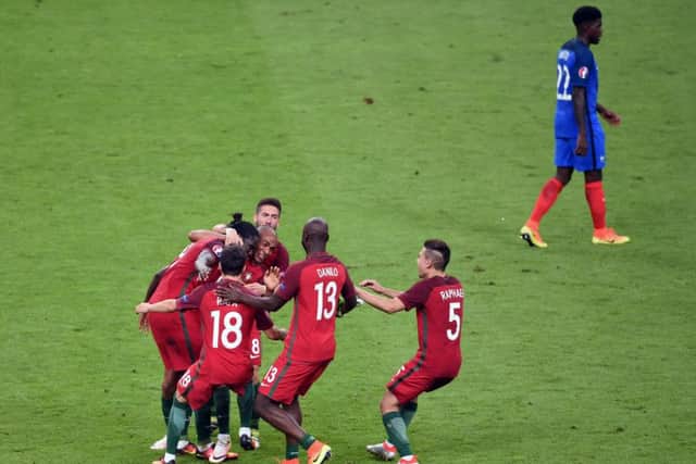 Portugal players celebrate after Eder (left, obscured) scores what proved to be the winning goal in Paris. Picture: Joe Giddens/PA.