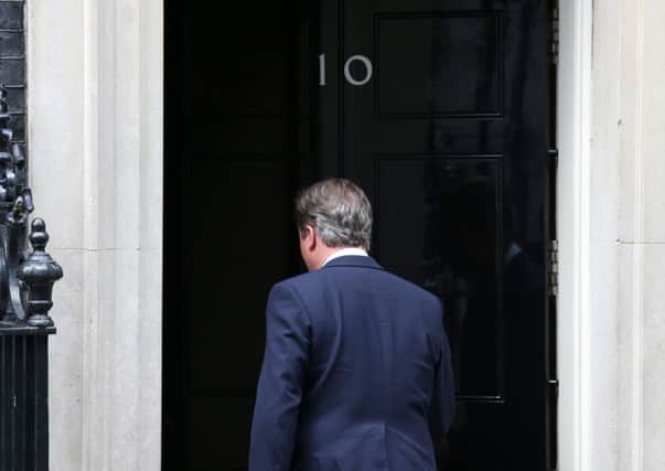 Prime Minister David Cameron after speaking to the media outside 10 Downing Street... he could be heard humming to himself as he went through the door.