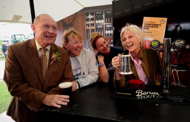 Gil Richardson, landlady of the Bull Inn West Tanfield, with Geoffrey Boycott and Yorkshire Rows Janette Benaddi and Helen Butters. .Picture by Simon Hulme