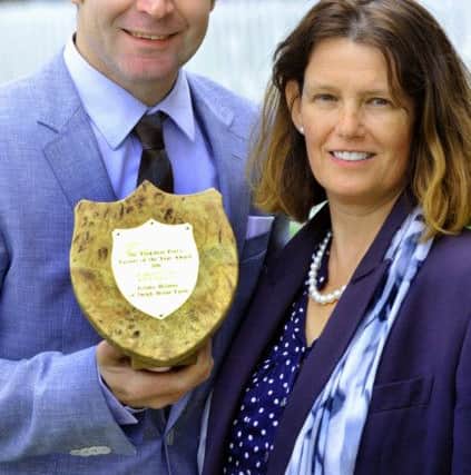 The winner of The Yorkshire Post's Farmer of the Year Award 2016, Jeremy Holmes from Delph House Farm, Denby Dale, being presented with the trophy by Julia Rangecroft of Mills & Reeve.