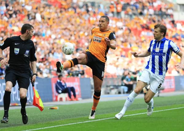 Hull City's Jake Livermore (centre) competes against Sheffield Wednesday's Glenn Loovens.