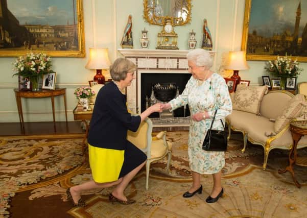 Queen Elizabeth II welcomes Theresa May at the start of an audience in Buckingham Palace, London, where she invited the former Home Secretary to become Prime Minister and form a new government. Image: Dominic Lipinski/PA Wire