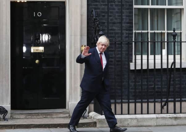 Boris Johnson leaves 10 Downing Street, central London, after being appointed Foreign Secretary, following a Cabinet reshuffle by new Prime Minister Theresa May. Steve Parsons/PA Wire