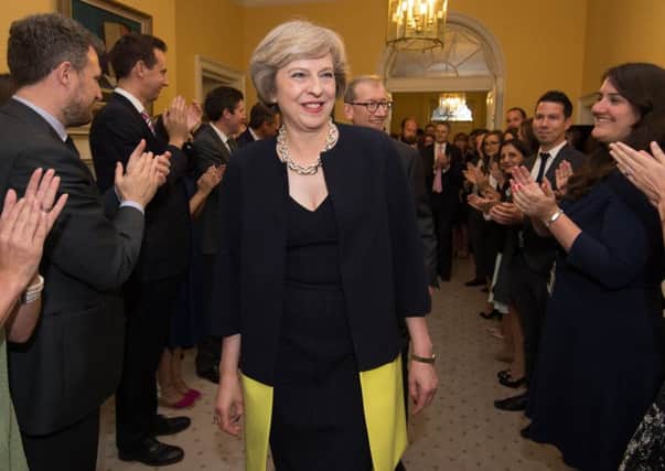 Staff clap as new Prime Minister Theresa May walks into 10 Downing Street after taking over from David Cameron as PM. (PA Wire).