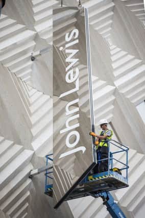 Â©Andrew McCaren/AM images 14/07/2016 Leeds UK. Picture shows the John Lewis sign being installed onto the side of the new store on the Headrow in Leeds.