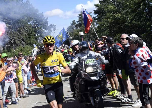 Britain's Chris Froome, wearing the overall leader's yellow jersey, runs to the finish after he crashed at the end of the 12th stage of the Tour de France (Picture: Stephane Mantey/Pool Photo via AP).
