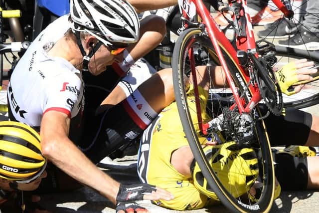 Britain's Chris Froome, wearing the overall leader's yellow jersey,lies on the road surface after a crash at the end of the 12th stage of the Tour de France (Picture: Bernard Papon/Pool Photo via AP).