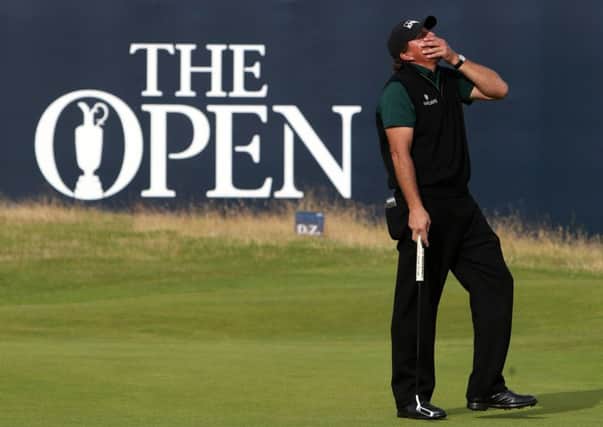 Phil Mickelson reacts after missing a putt that would have given him a 62 - the first in major history (Picture: Peter Byrne/PA Wire).