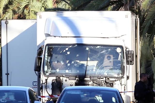 The truck which slammed into revelers late Thursday night is seen near the site of an attack in the French resort city of Nice, southern France, this morning.