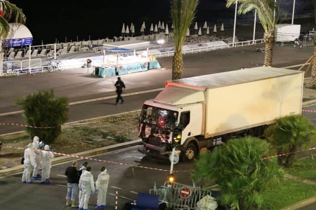 Authorities investigate a truck after it plowed through Bastille Day revelers in the French resort city of Nice. (Sasha Goldsmith via AP)