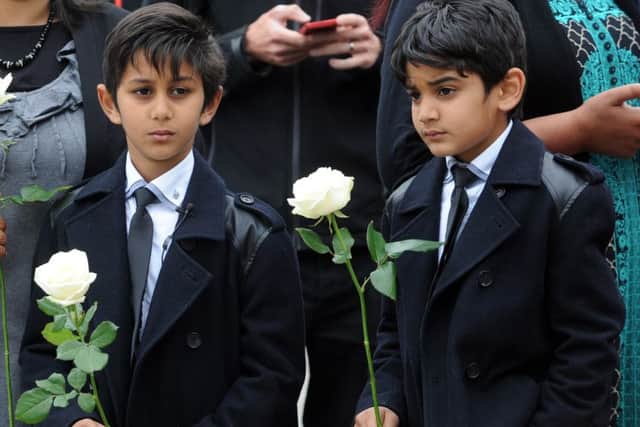 Two schoolchildren with white roses in memory of MP Jo Cox .Picture by Simon Hulme