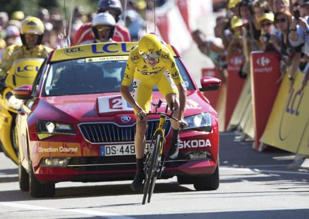 Team Sky's Chris Froome, wearing the overall leader's yellow jersey, crosses the finish line of the thirteenth stage of the Tour de France. Picture: AP /Peter Dejong