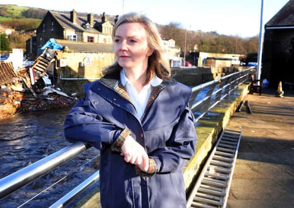 Elizabeth Truss pictured in January this year in Mytholmroyd following the Boxing Day floods. (Picture Tony Johnson).