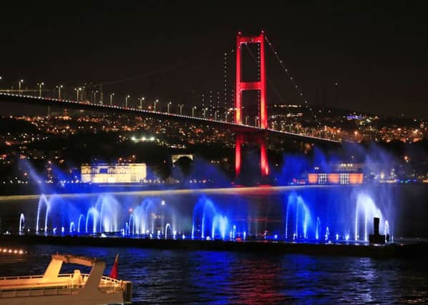 Istanbul's iconic Bosporus Bridge is lit in the colours of the French flag on Friday, July 15, 2016, in solidarity with the victims of Thursday's attack in Nice, France. The suspension bridge that connects Europe and Asia was adorned by the French tricolor a day after a Tunisian man drove a truck through crowds celebrating Bastille Day in the French resort town.
