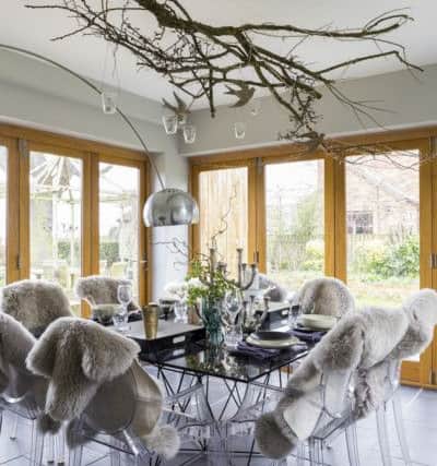 The extension has created a light, bright dining area. The branch hung with tea lights is one of Linda's creative ideas