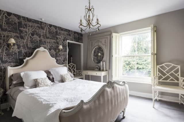 The French-style bed is from a trade supplier and the walpaper is Cow Parsley from Cole and Son