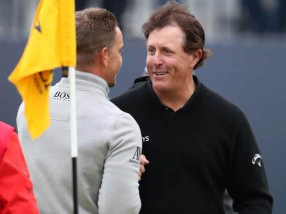 Henrik Stenson, left, and Phil Mickelson congratulate one another on the final green after Saturday'sd third round of The Open (Picture: Peter Byrne/PA Wire).