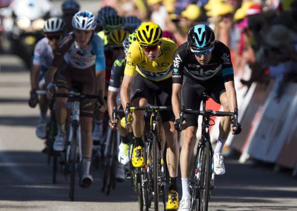 Britain's Chris Froome, wearing the overall leader's yellow jersey, crosses the finish line of the fifteenth stage of the Tour de France.