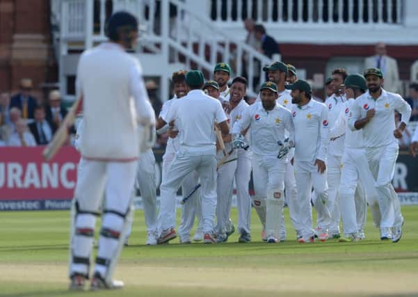 Pakistans players celebrate their victory in the first Test