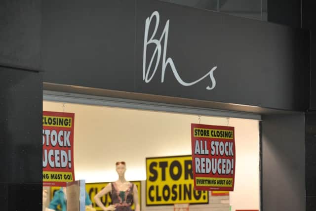 A BHS store displaying 'store closing' signs and posters.