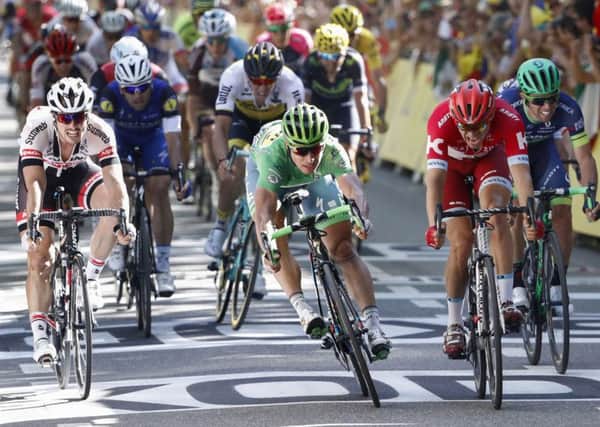 Peter Sagan of Slovakia, wearing the green jersey, crosses the finish line ahead of Norways Alexander Kristoff (Picture: AP).