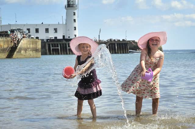 Sisters Paige Abell- Weck (6) and Faith Abell -Weck (7) cool off in the sea as Scarborough's south bay bakes in the July sunshine