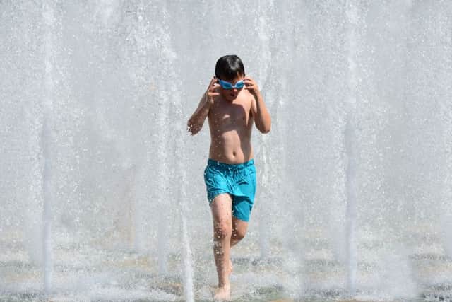 Childtren cool off in the fountains in Sheffield's Peace Gardens as temperatures soar. Picture: Scott Merrylees