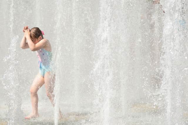 Childtren cool off in the fountains in Sheffield's Peace Gardens as temperatures soar.