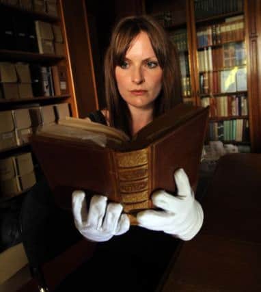 Library and Collections Officer Sarah Laycock looks at Mis Bronte's annotated copy of Robert Southeys 'The Remains of Henry Kirke' at the Bronte Parsonage Museum, Haworth.
Picture by Simon Hulme